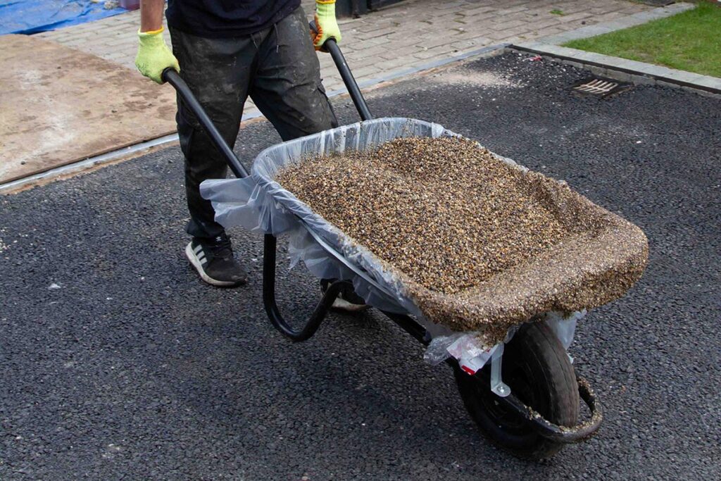 Transporting the mix by wheelbarrow to the work area